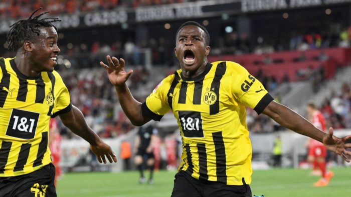 Dortmund's English forward Jamie Bynoe-Gittens (L) and Dortmund's German forward Youssoufa Moukoko celebrate the 1-3 during the German first division Bundesliga football match between SC Freiburg and Borussia Dortmund in Freiburg im Breisgau, southwestern Germany on August 12, 2022. - DFL REGULATIONS PROHIBIT ANY USE OF PHOTOGRAPHS AS IMAGE SEQUENCES AND/OR QUASI-VIDEO (Photo by THOMAS KIENZLE / AFP) / DFL REGULATIONS PROHIBIT ANY USE OF PHOTOGRAPHS AS IMAGE SEQUENCES AND/OR QUASI-VIDEO (Photo by THOMAS KIENZLE/AFP via Getty Images)
