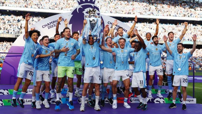 Soccer Football - Premier League - Manchester City v West Ham United - Etihad Stadium, Manchester, Britain - May 19, 2024  Manchester City's Kyle Walker and teammates celebrate with the trophy after winning the Premier League REUTERS/Molly Darlington EDITORIAL USE ONLY. NO USE WITH UNAUTHORIZED AUDIO, VIDEO, DATA, FIXTURE LISTS, CLUB/LEAGUE LOGOS OR 'LIVE' SERVICES. ONLINE IN-MATCH USE LIMITED TO 120 IMAGES, NO VIDEO EMULATION. NO USE IN BETTING, GAMES OR SINGLE CLUB/LEAGUE/PLAYER PUBLICATIONS. PLEASE CONTA