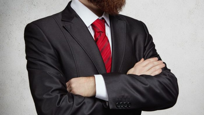 cropped-view-attractive-successful-entrepreneur-with-thick-beard-standing-with-arms-folded-office-thinking-something-important-picture-serious-confident-man