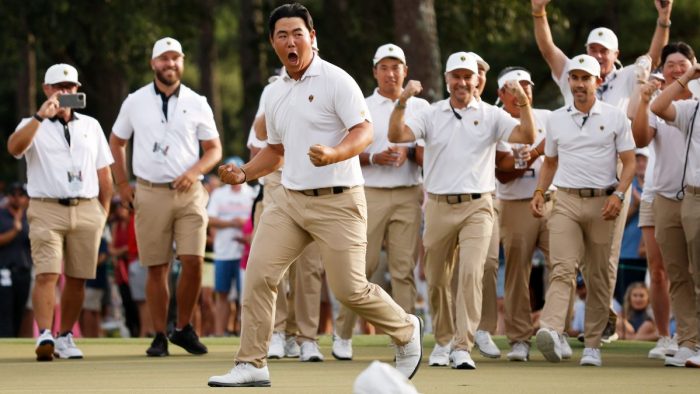 CHARLOTTE, NORTH CAROLINA - SEPTEMBER 24: Tom Kim of South Korea and the International Team celebrates his hole-winning putt to win the match 1 Up with teammate Si Woo Kim of South Korea against Patrick Cantlay and Xander Schauffele of the United States Team during Saturday afternoon four-ball matches on day three of the 2022 Presidents Cup at Quail Hollow Country Club on September 24, 2022 in Charlotte, North Carolina. (Photo by Jared C. Tilton/Getty Images)