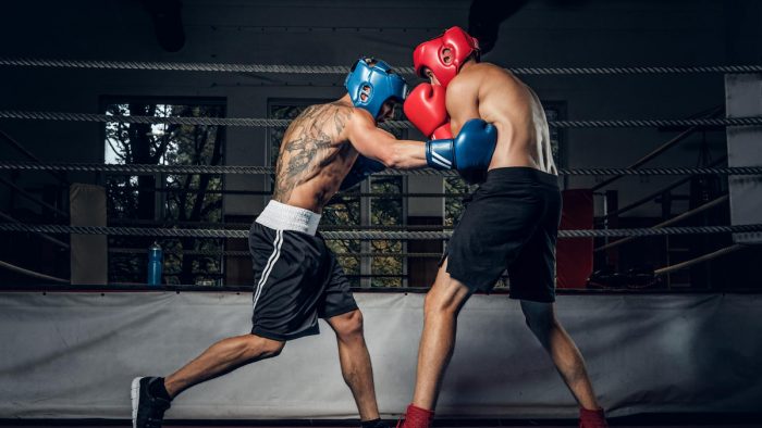 two-muscular-boxers-have-competition-ring-they-are-wearing-helmets-gloves